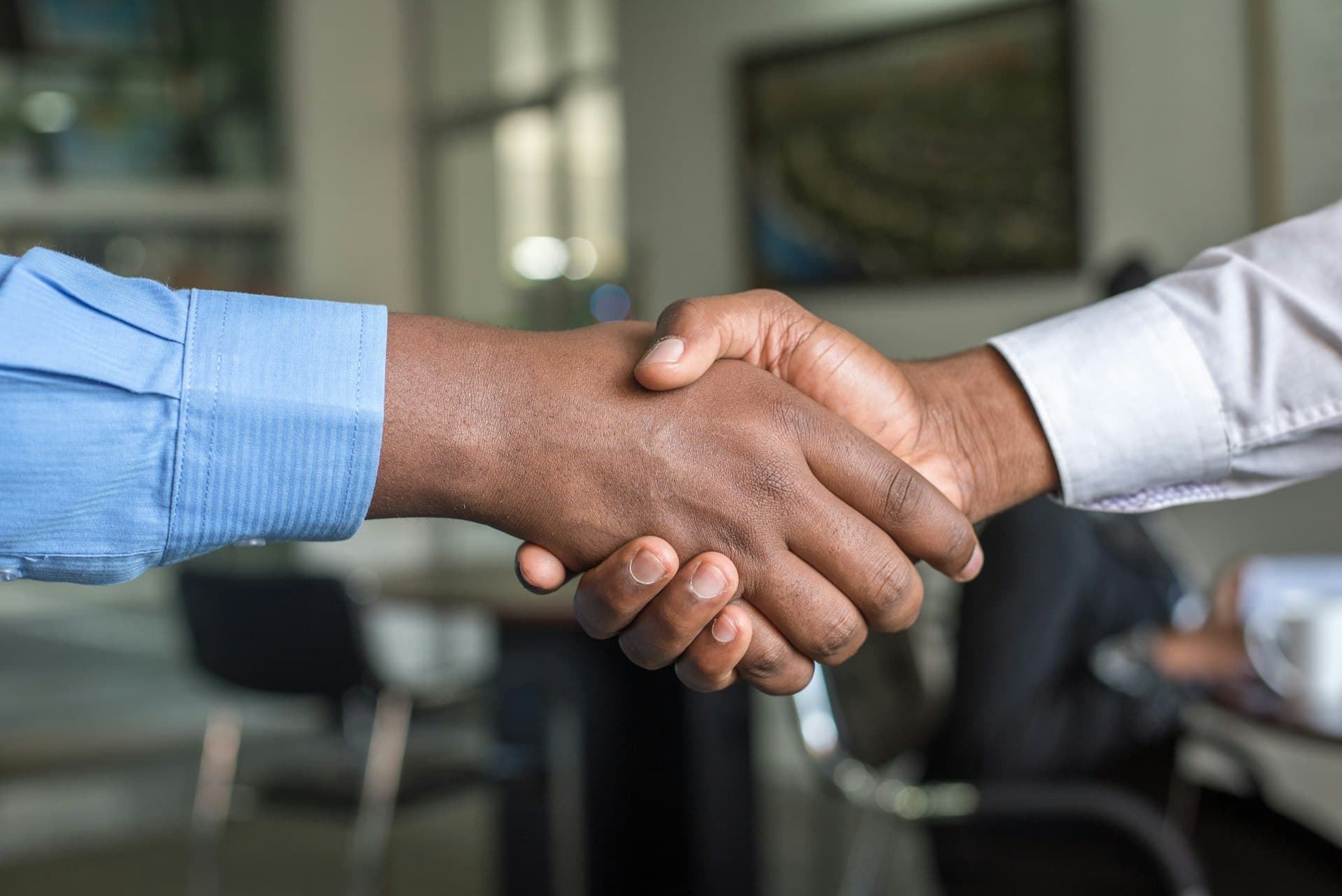 Attorney shaking hands with a client at Jody D. Peterman, LLC